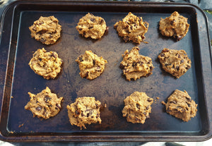 baking sheet with twelve chickpea raisin chocolate chip cookies